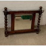 An oak hall mirror with hooks to side