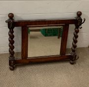 An oak hall mirror with hooks to side