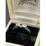 An 18ct gold and platinum set sapphire ring with diamond shoulders.