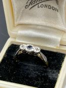 An 18ct gold and platinum set sapphire ring with diamond shoulders.