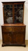 A George III style secretaries chest, fall front enclosing a fitted interior of drawers and pigeon