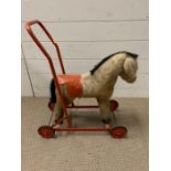 A vintage push a long toy horse