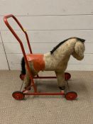 A vintage push a long toy horse