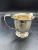 A silver milk jug, hallmarked for Birmingham 1936 by Selfridge & Co Ltd