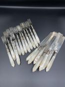 A Ten piece setting of silver knives and forks with mother of pearl handles. Hallmarked for