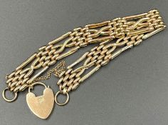 A 9ct gold gate bracelet with heart shaped fastener and safety chain (11.4g)