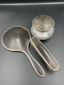 A Walker and Hall three piece silver and tortoiseshell style vanity set to include brush, pot and
