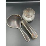 A Walker and Hall three piece silver and tortoiseshell style vanity set to include brush, pot and