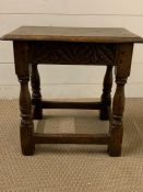 An oak carved stool or side table on turned legs (H45cm W45cm D25cm)