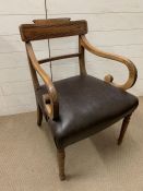An oak elbow chair with splat back and scrolled arms