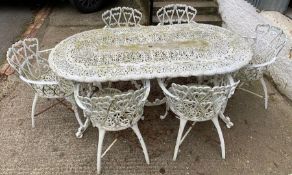 A reclaimed cast iron six seater garden table cast in a heart scrolling design and accompanying