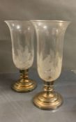 A pair of white metal and engraved glass candle lanterns