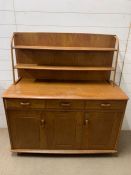 A Mid Century Ercol sideboard with plate rack (H77cm W120cm D49cm)