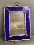 A glass wall mirror with cobalt blue boarder and twisted glass rods finished to each corner with