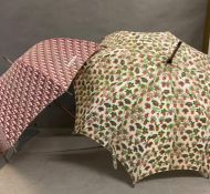 A Christine Dior vintage sunshade umbrella along with a vintage Harrods sun umbrella