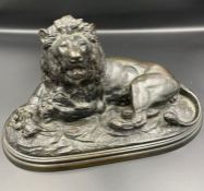 A Bronze of a recumbent lion in the manner of Edouard Delabrierre (French 1829-1912) signed