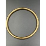 A 15ct gold bangle (Total weight 10.5g)