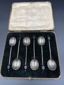 A boxed set of six silver coffee spoons with coffee bean ends by Cross Brothers and hallmarked for