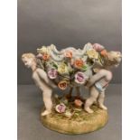 A Meissen centrepiece or fruit bowl with floral decoration supported by three cherubs