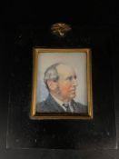 A miniature portrait of a gentleman in a black frame