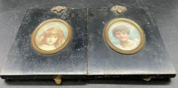 Two miniature portraits of a young girl and a young woman in matching black frames