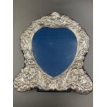 A silver heart shaped photo frame with easel back, hallmarked for Sheffield 1992 by Carr's of