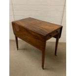 A mahogany Pembroke table with frieze drawer and one working drawer on square tapering legs with