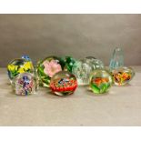 A selection of various glass paperweights