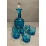 A set peacock blue liqueur jug/decanter with inner moulded panels, flared rim with pinched lip. tall