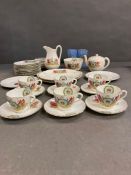 A Royal commemorative tea service to include cake plates, side plates, six cups and saucers, tea
