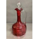 An 19th Century ruby glass wine jug with inner moulded panels, flared rim with pinched lip, tall