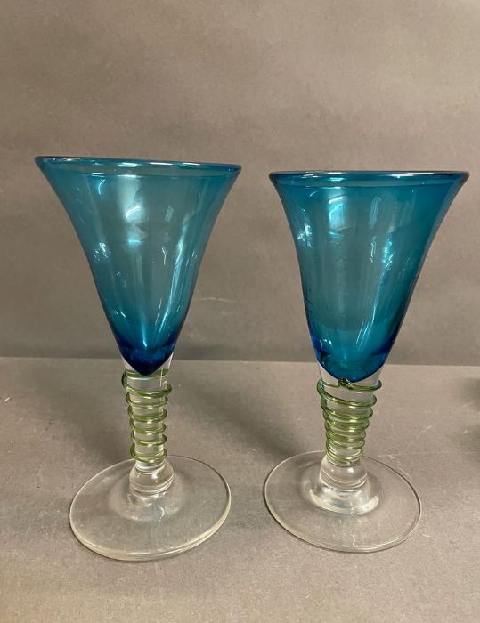 A pair of large blue glasses with applied stem