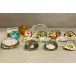 A selection of various glass paper weights