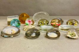 A selection of various glass paper weights