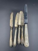 Five silver handled knives