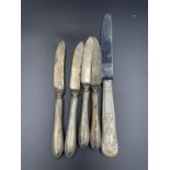 Five silver handled knives