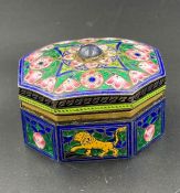 An enamel pill box with gilded interior.