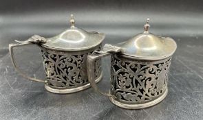 Two Elkington & Co Ltd silver mustards with blue glass liners, hallmarked for Birmingham 1900.