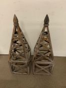 A pair of decorative wooden obelisks