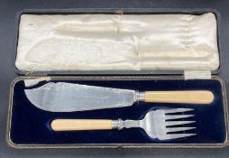 A fish serving set, with hallmarked silver collars