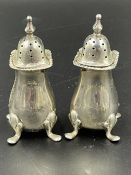 A pair of hallmarked silver pepper pots