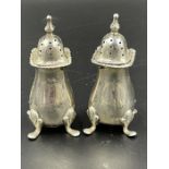 A pair of hallmarked silver pepper pots