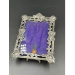 An ornate silver photo frame with an easel back, hallmarked for London 1879 by Robert Humphries