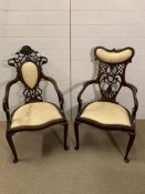 A pair of his and hers open armchairs with pierced backs