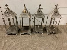 Four storm lanterns, candle holders, without glass