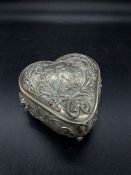 A silver lidded repousse Continental silver box on claw feet, marked 800.