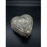 A silver lidded repousse Continental silver box on claw feet, marked 800.