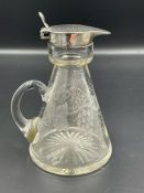 A small glass jug with grape and vine leaves etched design and silver pourer by RR hallmarked for