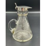 A small glass jug with grape and vine leaves etched design and silver pourer by RR hallmarked for