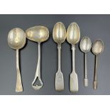 A selection of silver spoons with various hallmarks and makers.